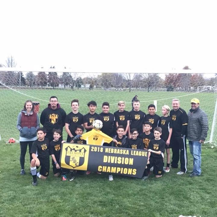 Youth soccer team holding a championship banner